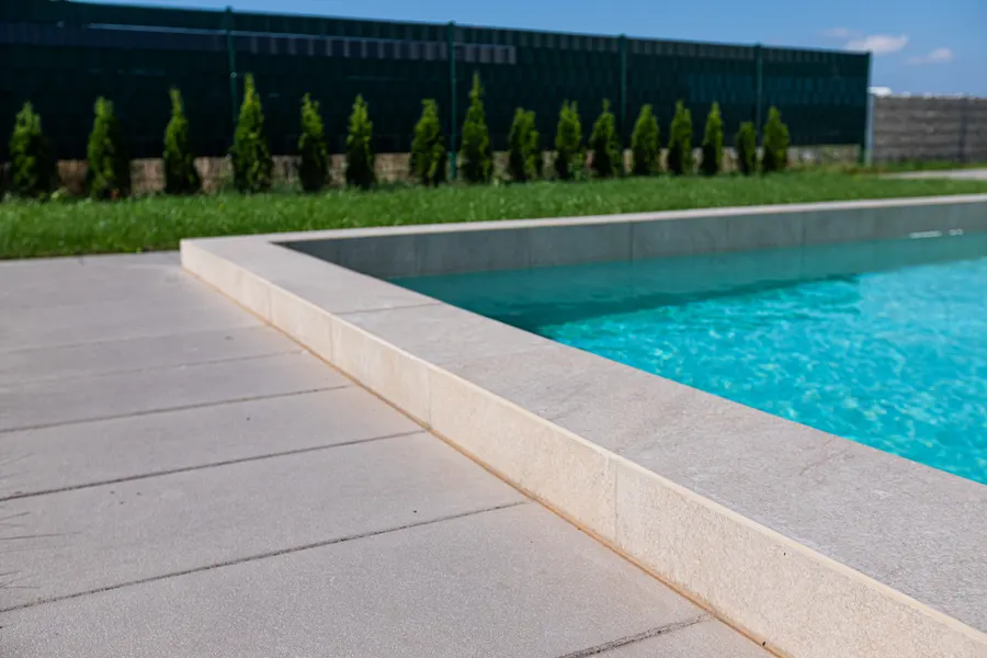 Poolumrandung und Terrasse aus Naturstein, verlegt von Linnemeier Fliesenfachgeschäft